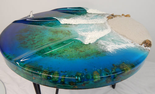Resin art coffee table with 3D waves peeling over a hand painted reef. Deep pour resin ocean with fish and a whale breaching.