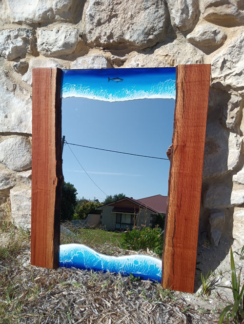 Mirror framed by ocean and wood