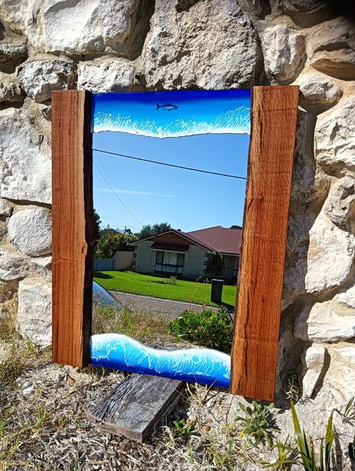 Mirror framed by ocean and wood