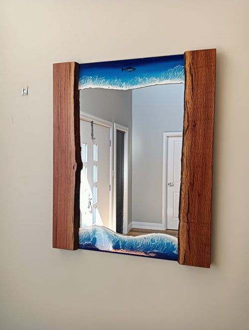 Mirror framed by ocean and wood