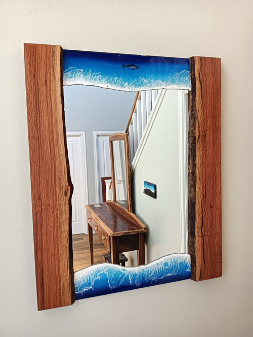Mirror framed by ocean and wood